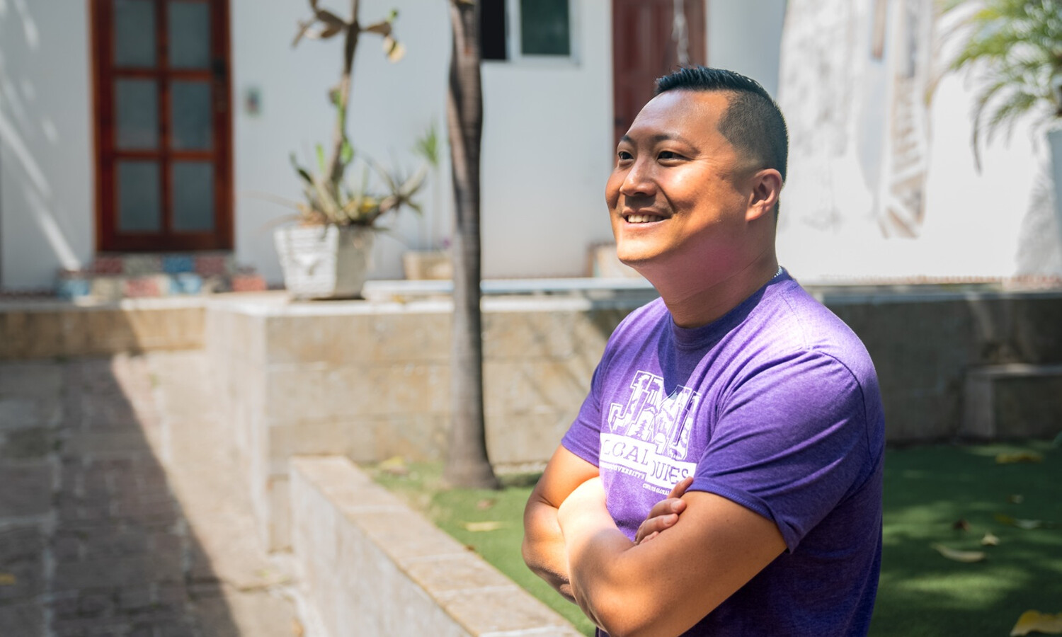 Dr. Felix Wang smiling with his arms crossed in the Dominican republic.