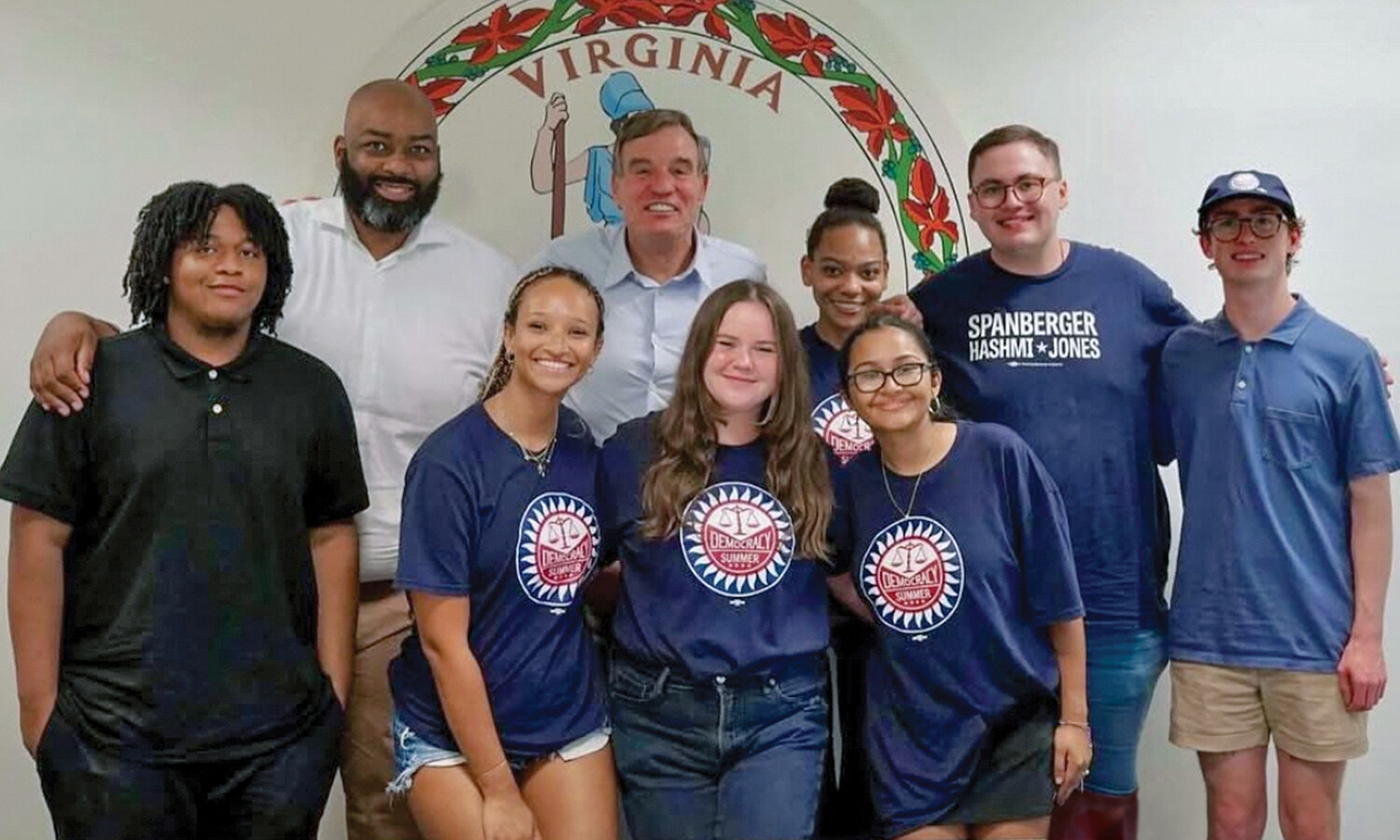 Student Fellows pose for a photo with Sen. Mark Warner and Del. Lamont Bagby.
