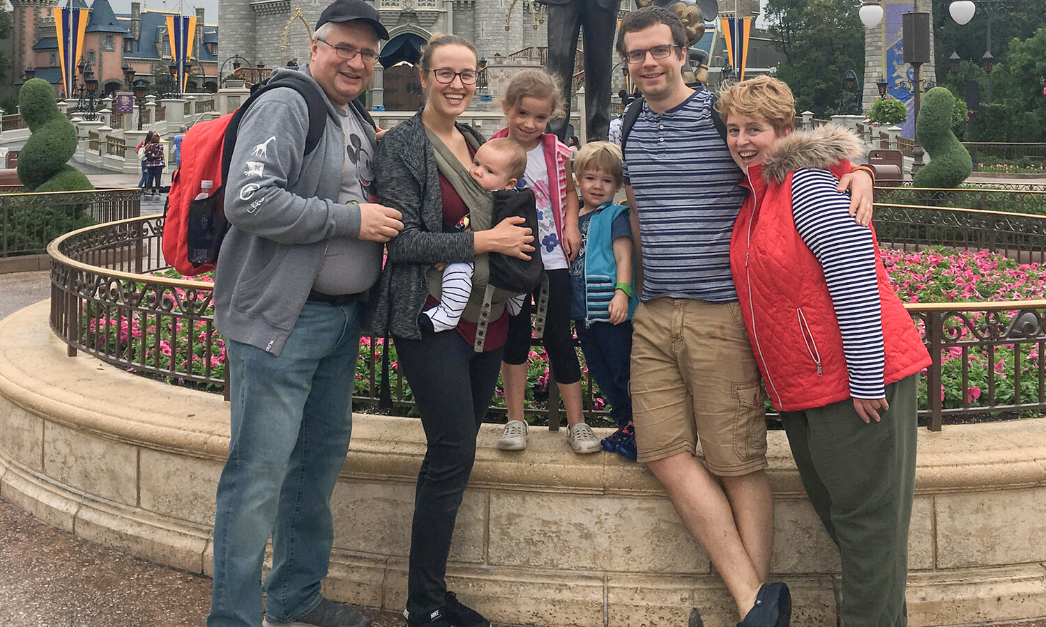 Family posing in front of the castle at Disney World.